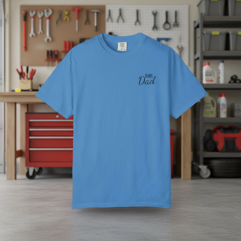 Blue t-shirt with 'Girl Dad' text in a workshop setting