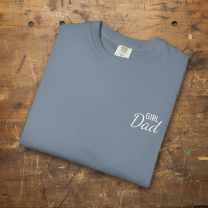 Folded blue t-shirt with 'Girl Dad' text on a white background