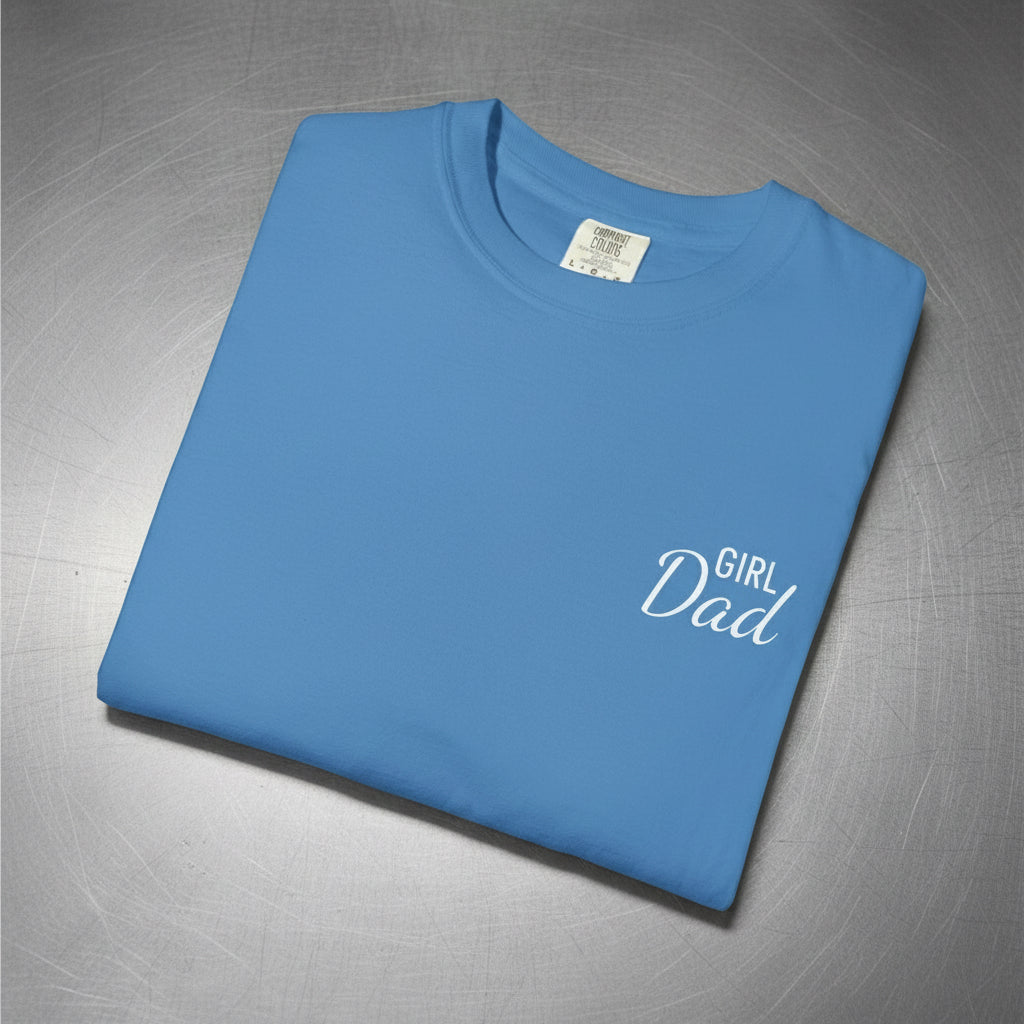 Folded blue t-shirt with 'Girl Dad' text on a white background